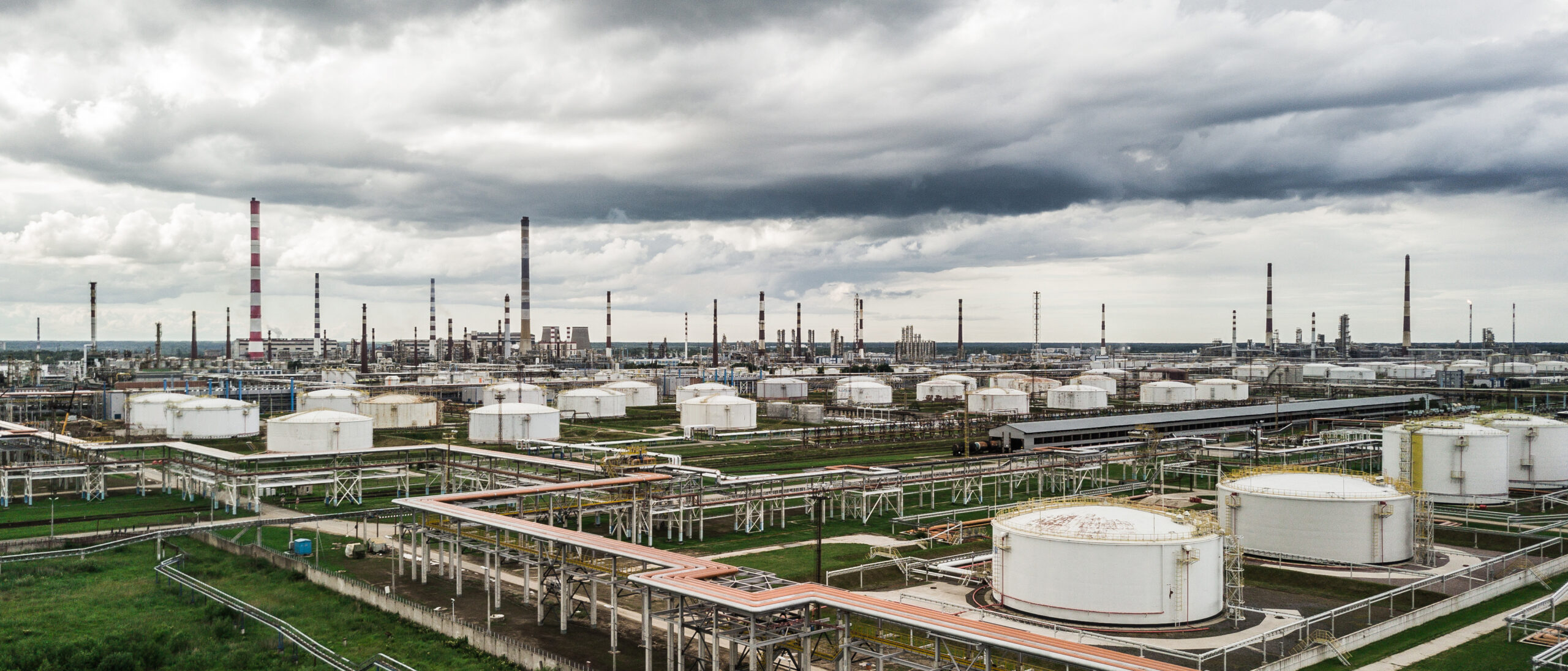 Aerial view of huge oil refinery with smokestacks and tanks